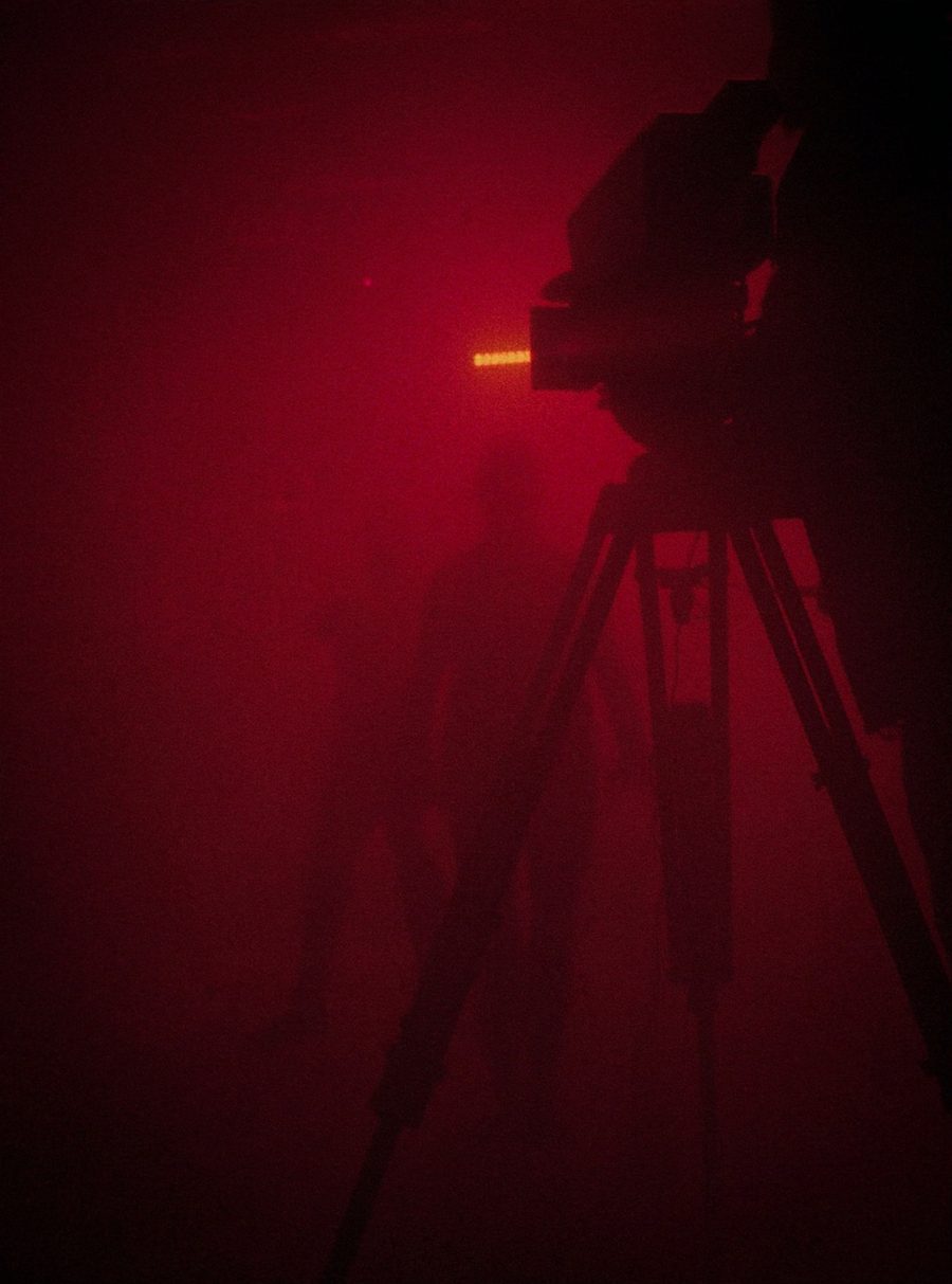 Film and content — cinema camera on a red-lit stage